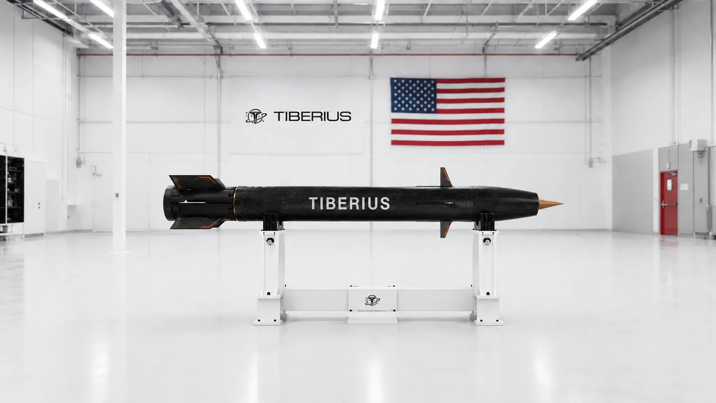 SCEPTRE round on its display stand in the Tiberius production hall, beneath the company banner and American flag