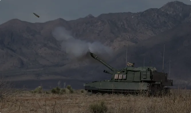 A self-propelled howitzer firing on a desert range.
